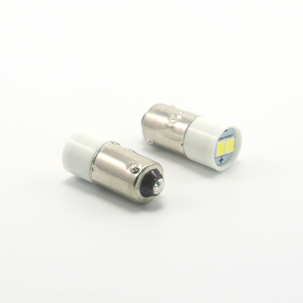 Close-up of nickel-plated brass BA9s miniature bayonet base and single bottom contact