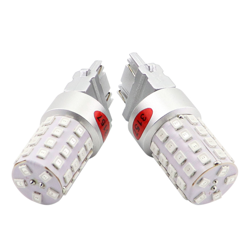T25 3157 dual circuit LED bulb macro view of bottom wedge electrical contacts and top optical lens array