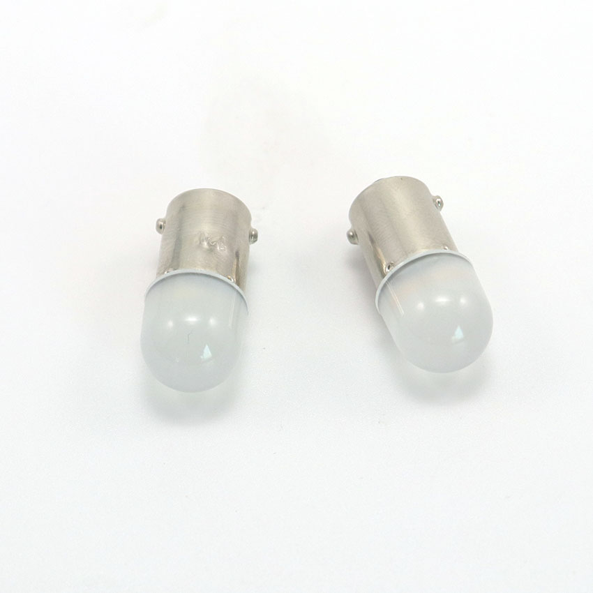 Dual compact frosted BA9s T4W LED pilot lamps side-by-side macro optical comparison